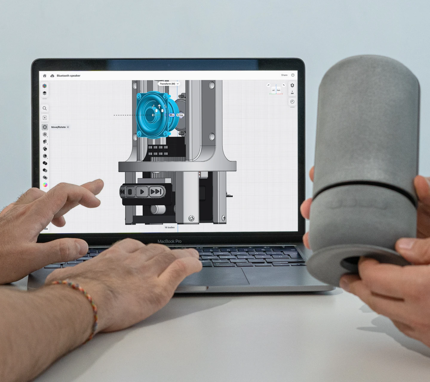 Engineer comparing a CAD model with a 3D printed prototype